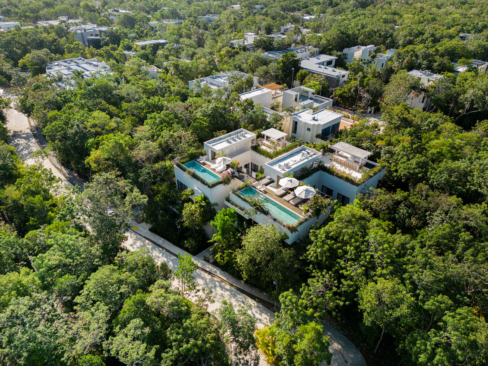 Villa Imperia in Tulum Aerial view of villa rooftop terraces with multiple living/dining space and 2 pools